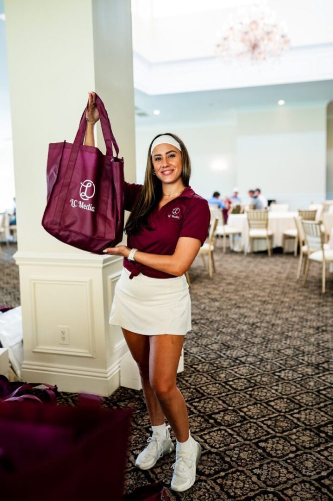 A woman holding a bag in a room.