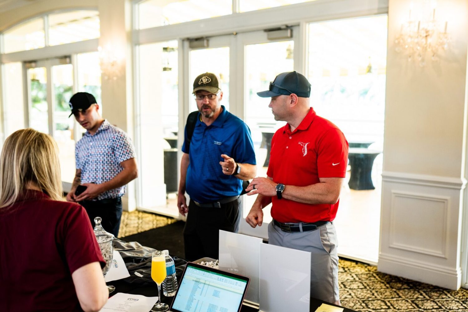 A group of men standing around a table.