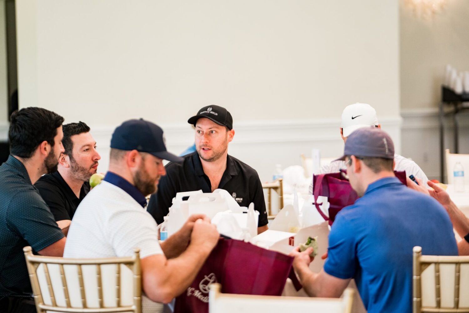 A group of men sitting around each other.