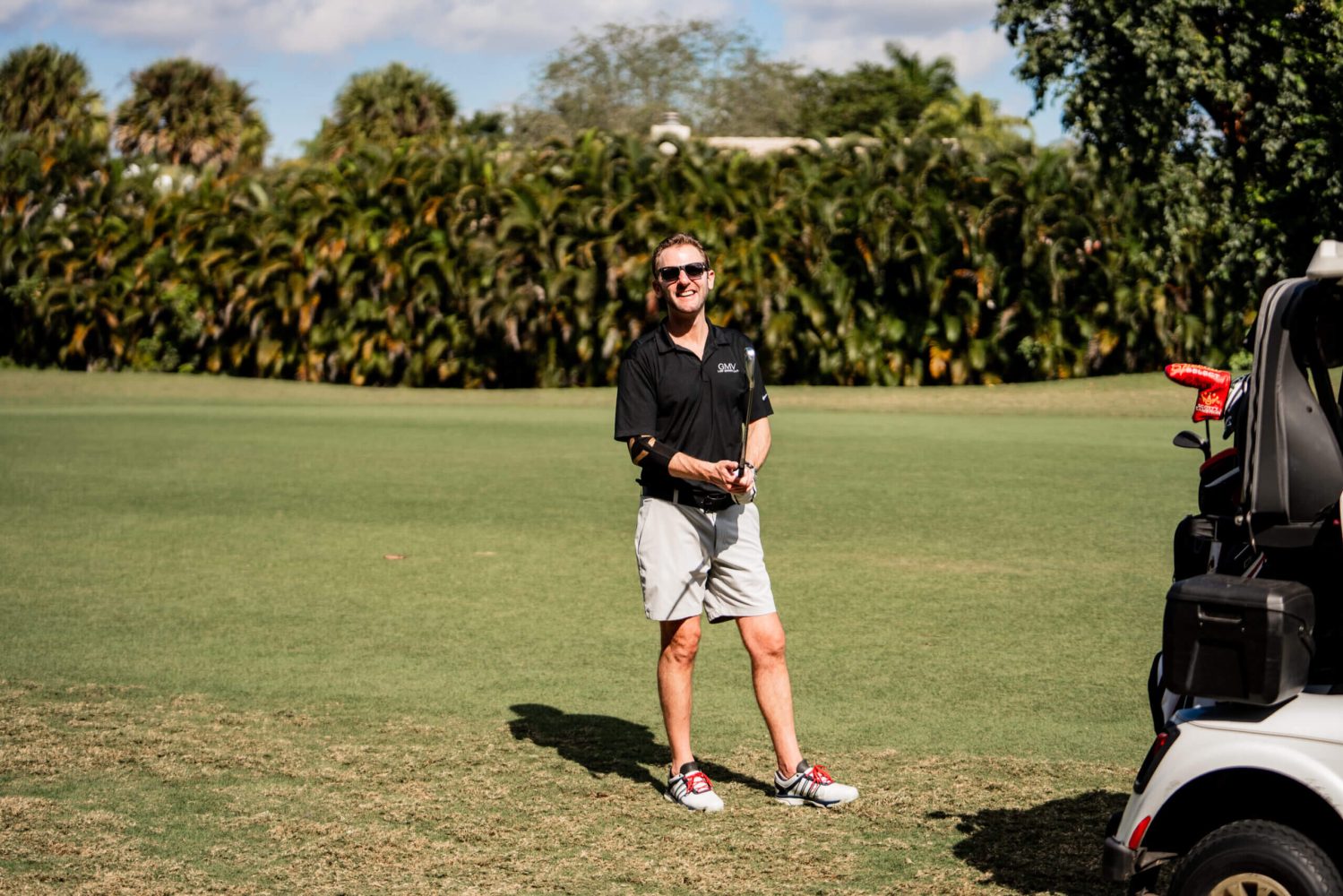A man standing on top of a grass covered field.
