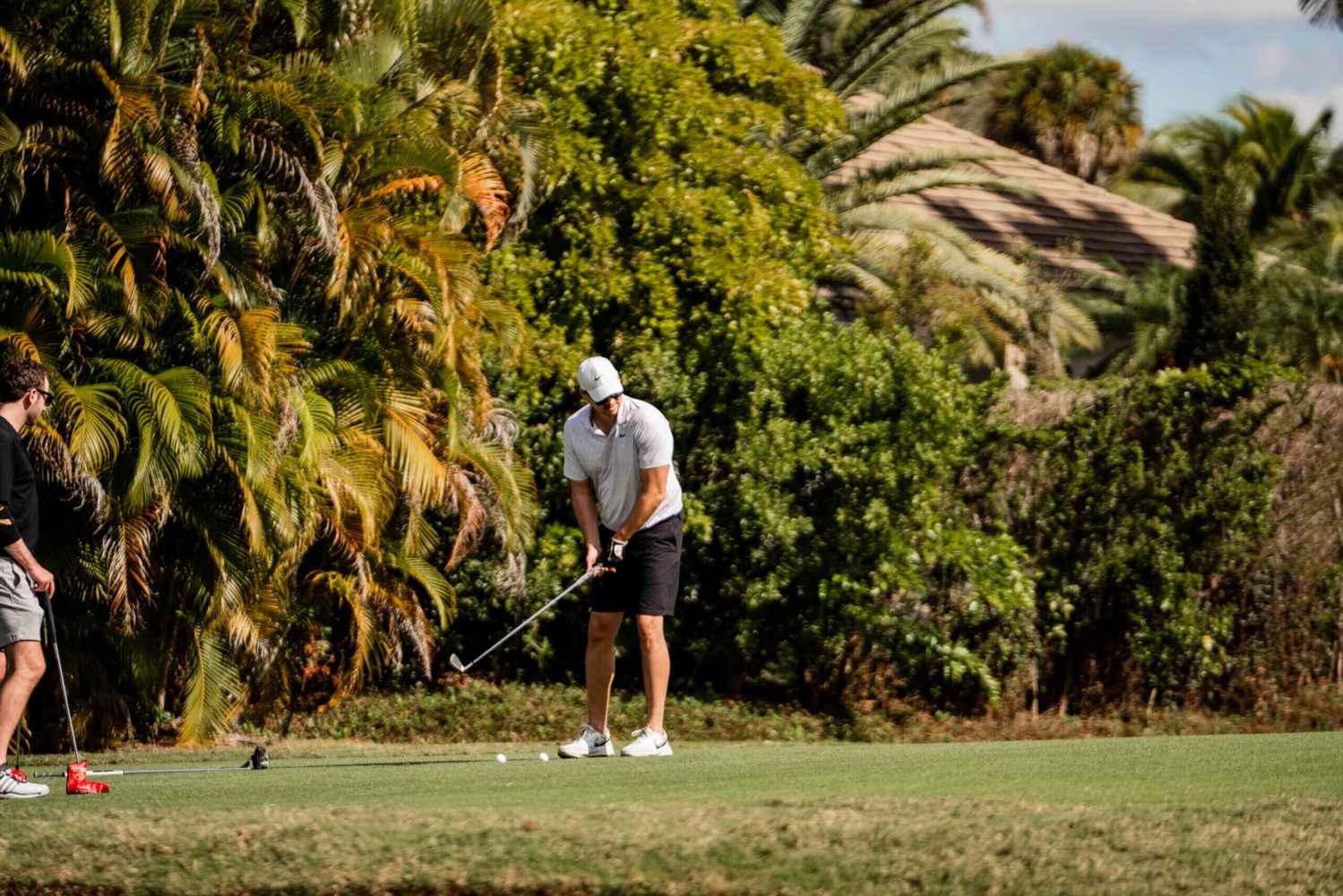 A man is playing golf on the green