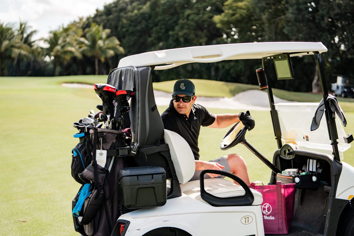 A man sitting in the back of a golf cart.