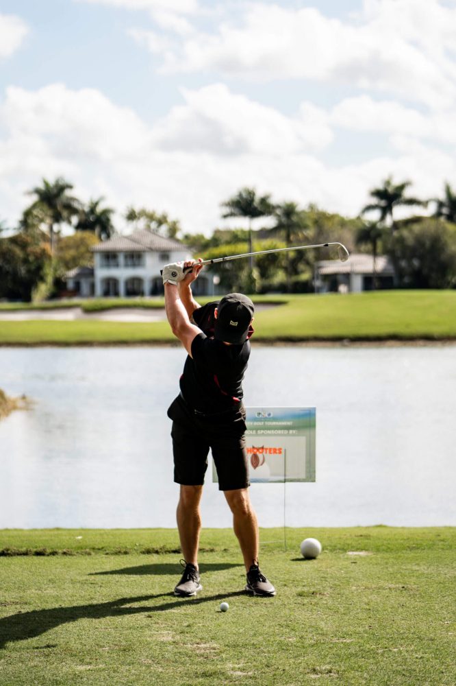 A man is playing golf on the course