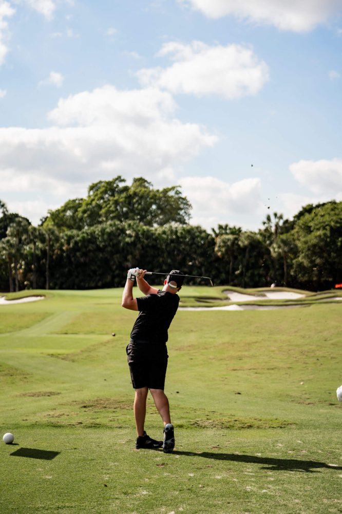 A woman is playing golf on the green