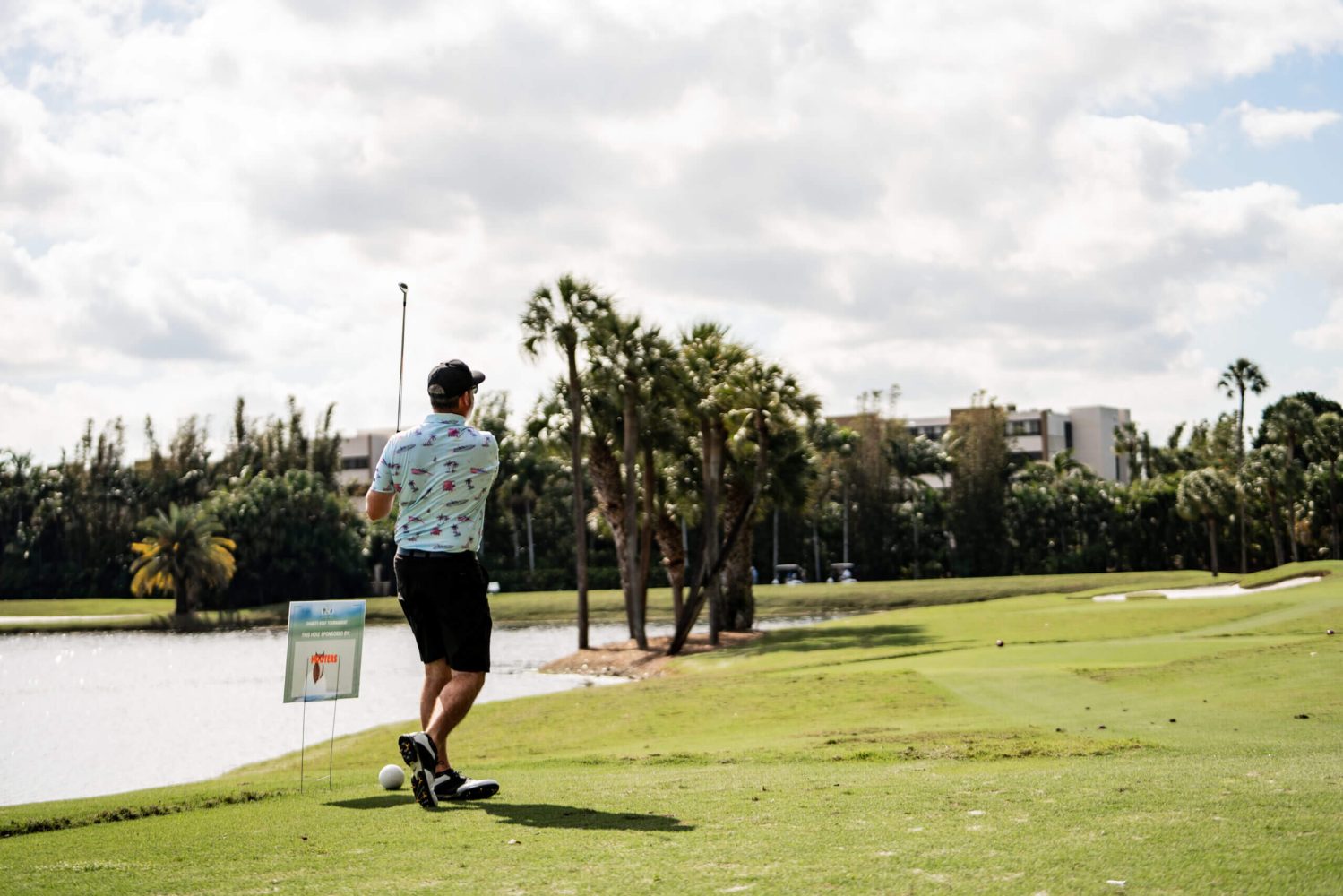 A man riding a skateboard across the grass.