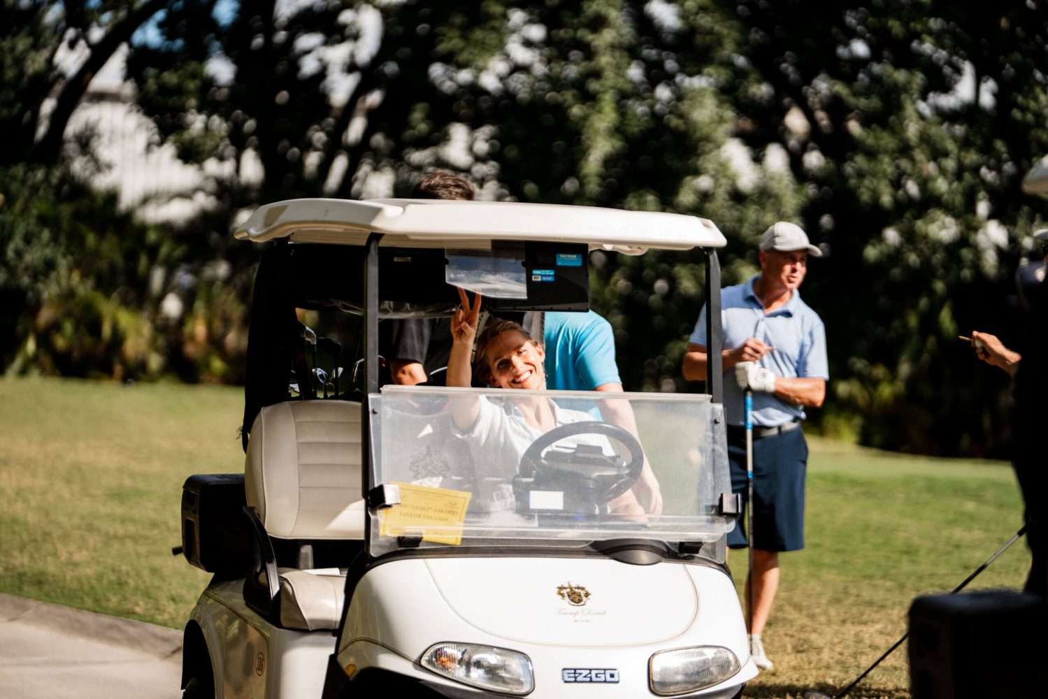 A group of people in a golf cart.