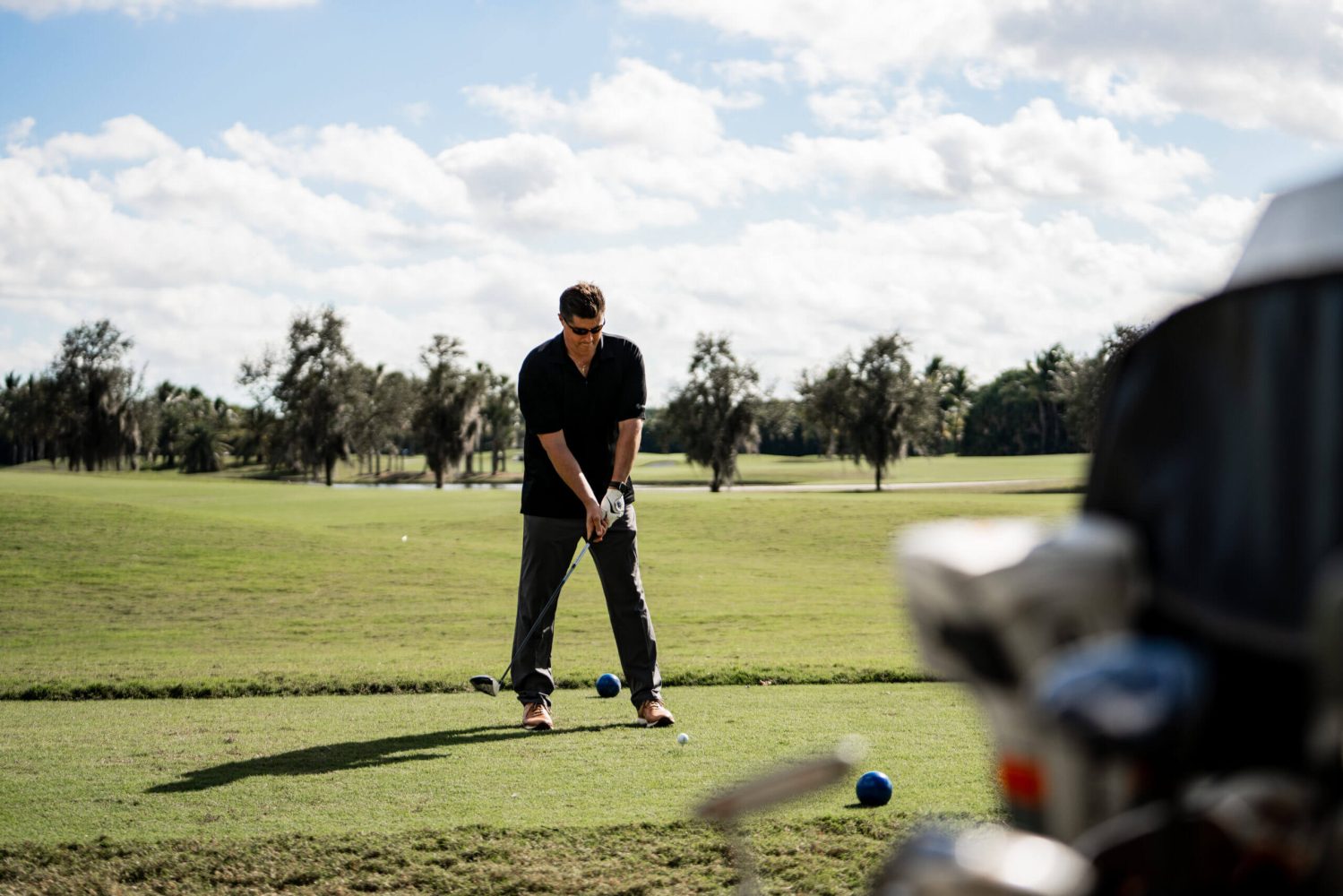 A man is playing golf on the green