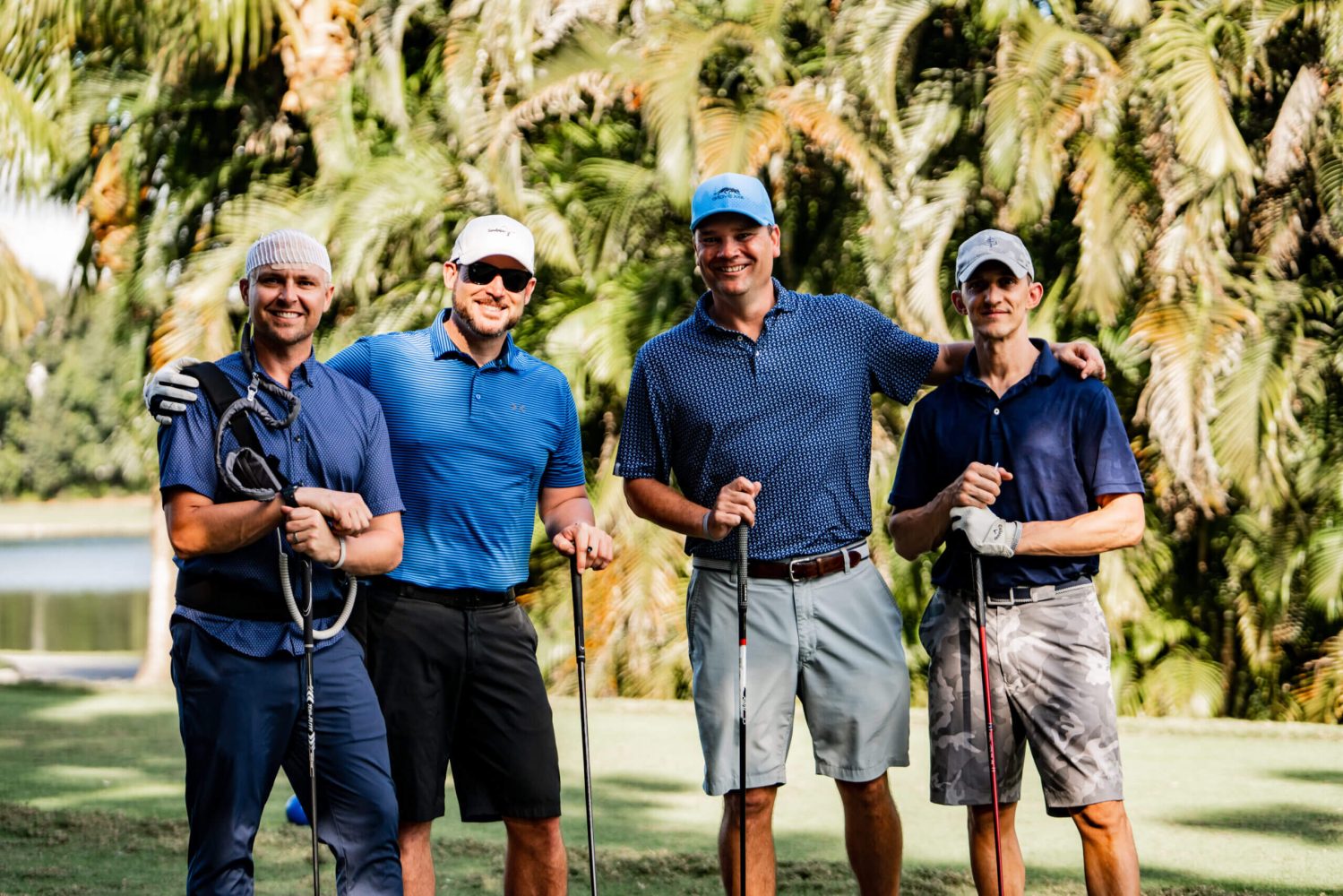 A group of men standing next to each other on a golf course.