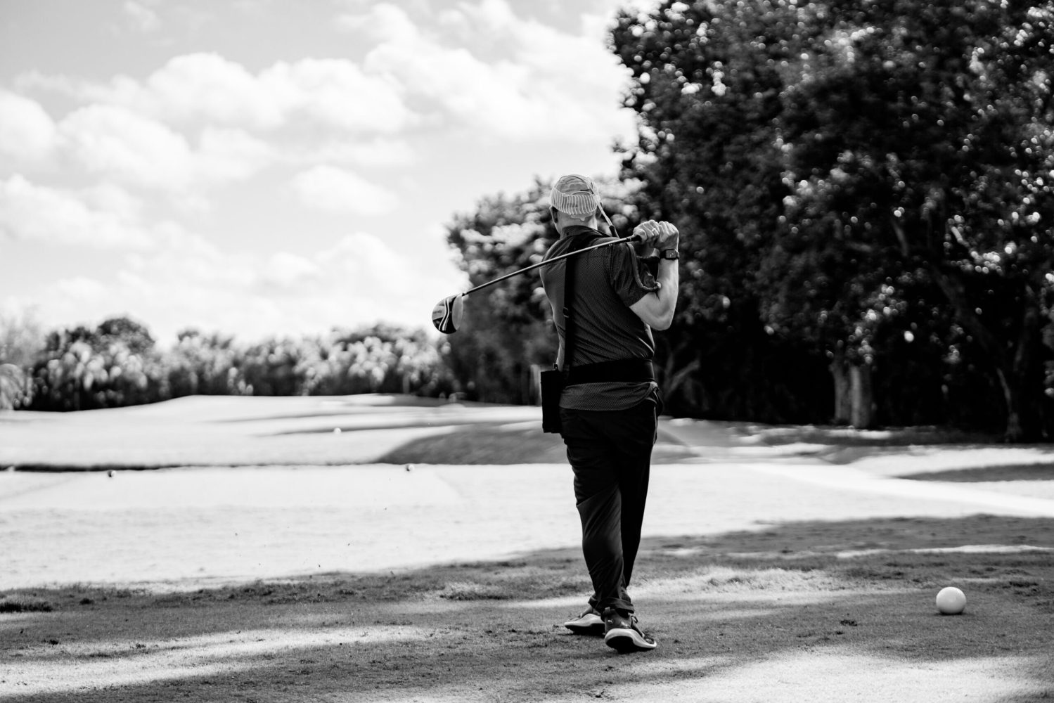 A man walking down the street in black and white.