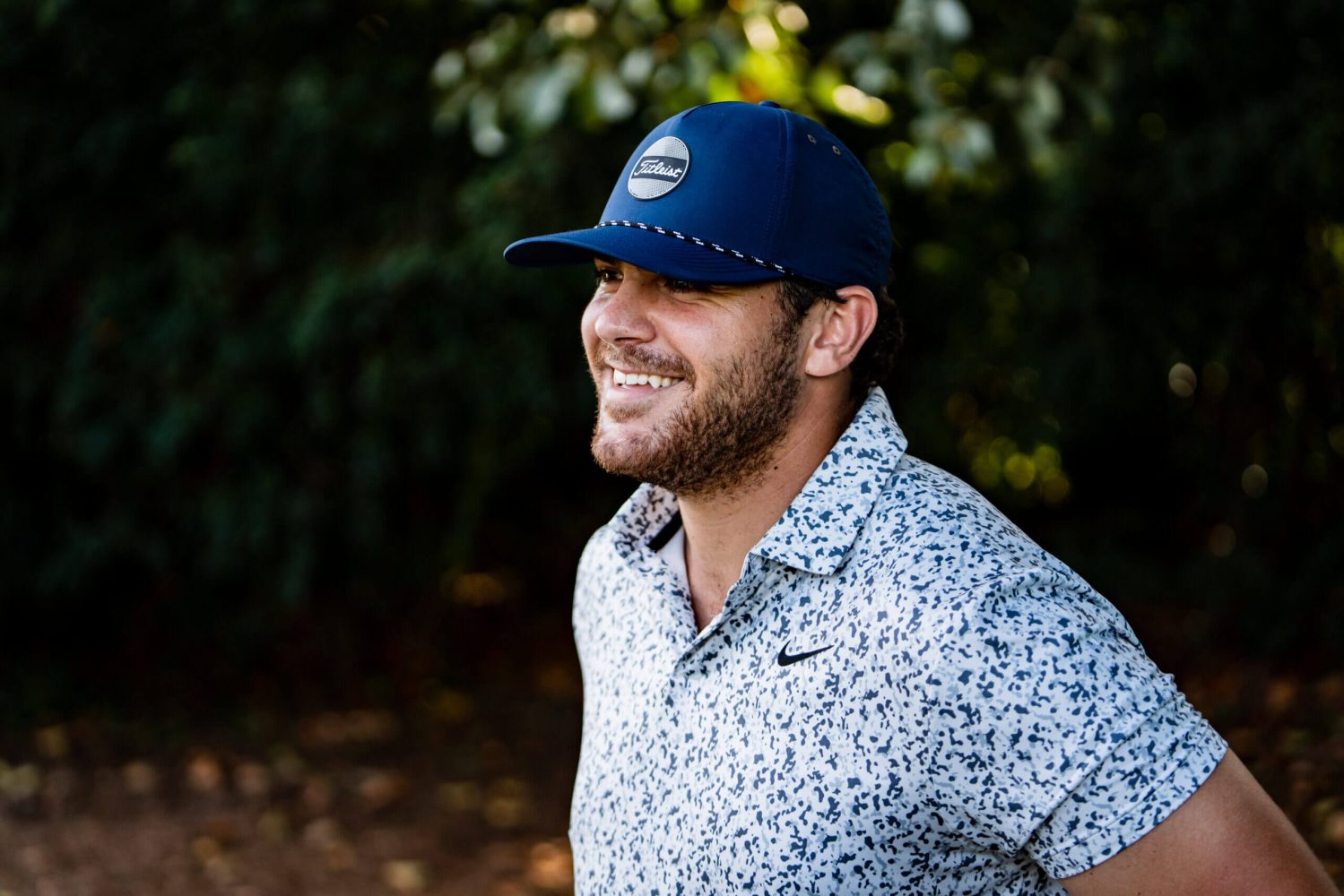 A man wearing a blue hat and smiling.