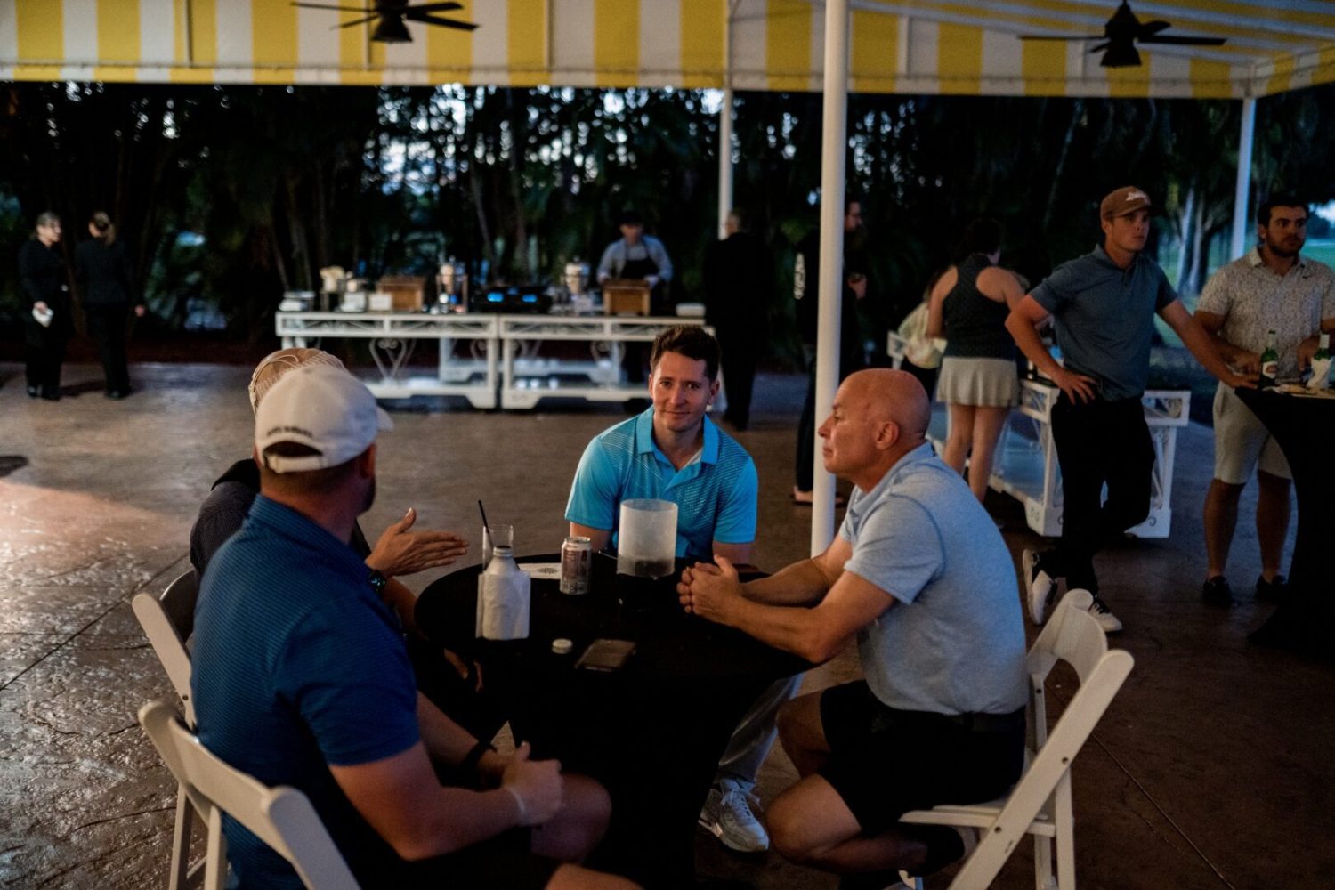 A group of men sitting around a table.