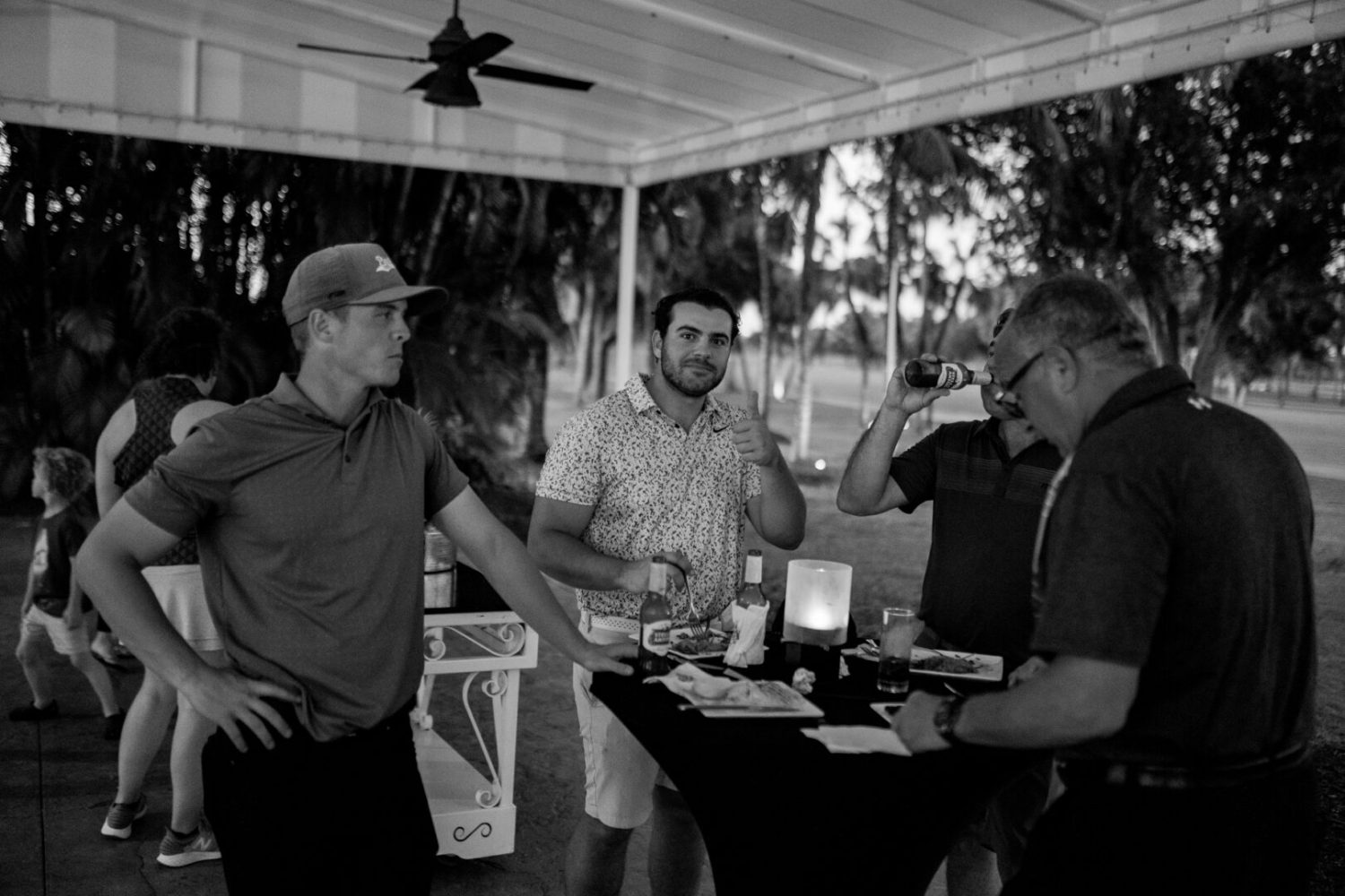 A group of people standing around a table.