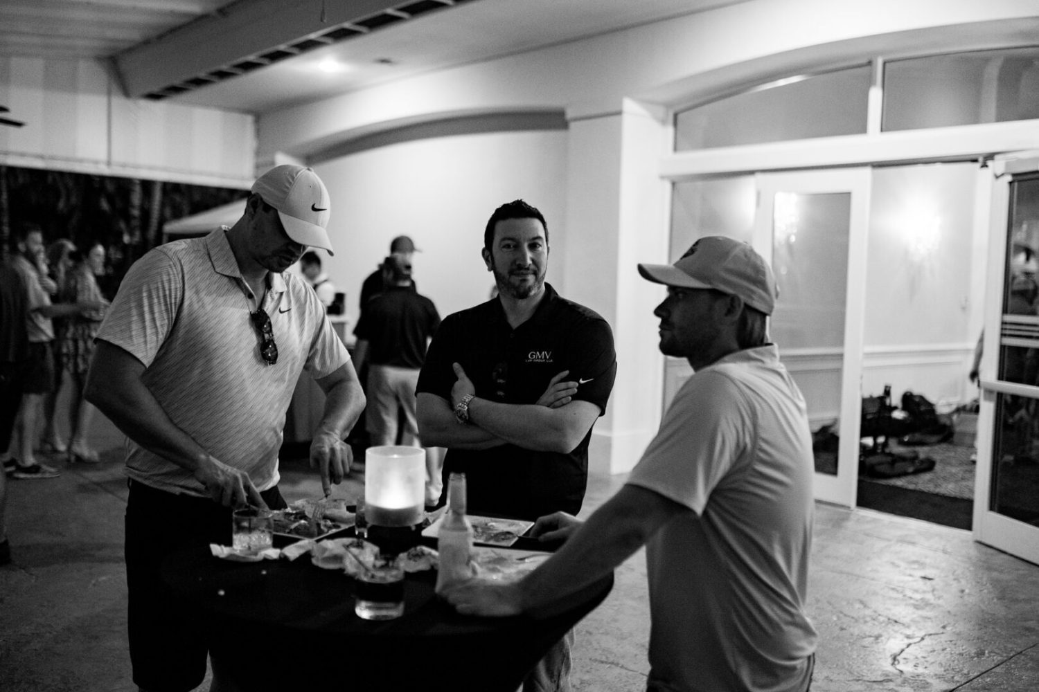 A group of men standing around a table.