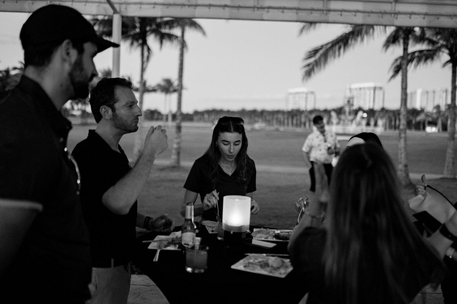 A group of people standing around a table.