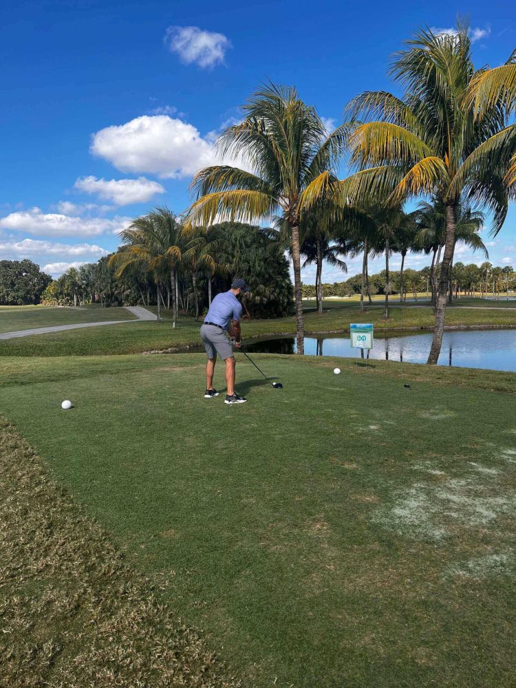 A man is playing golf on the green