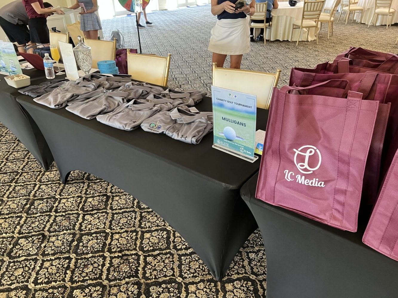 A table with several bags and some papers on it