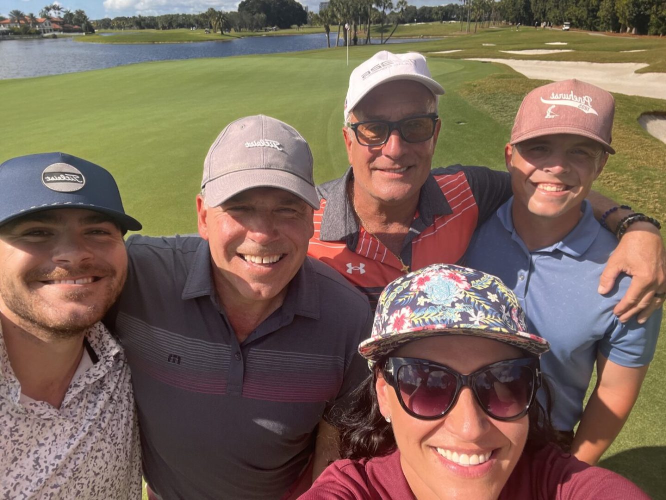 A group of people taking a selfie on the golf course.