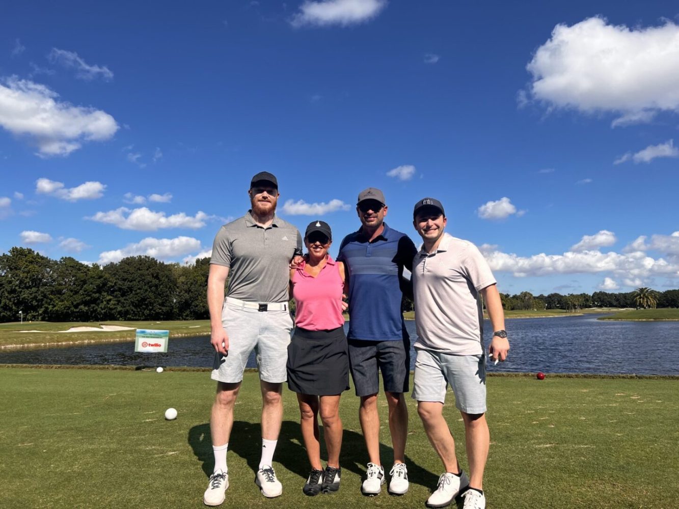 A group of people standing on top of a green.