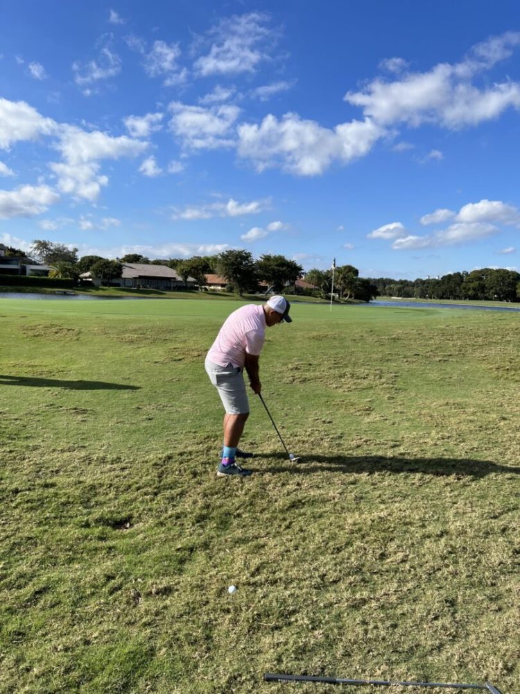 A man is playing golf on the grass