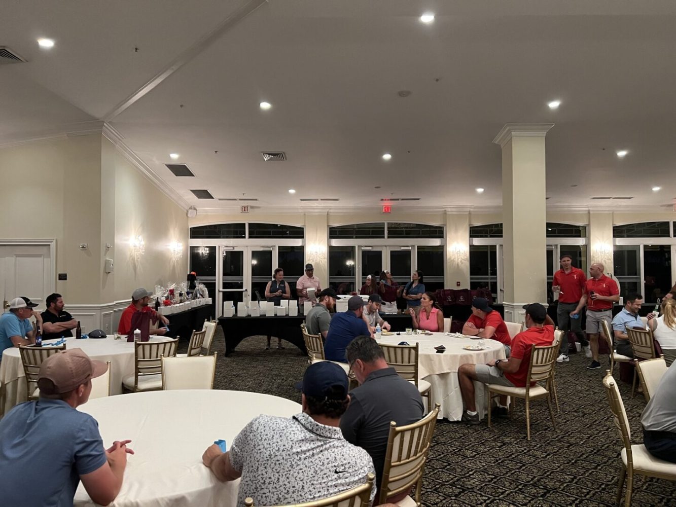 A group of people sitting at tables in a room.