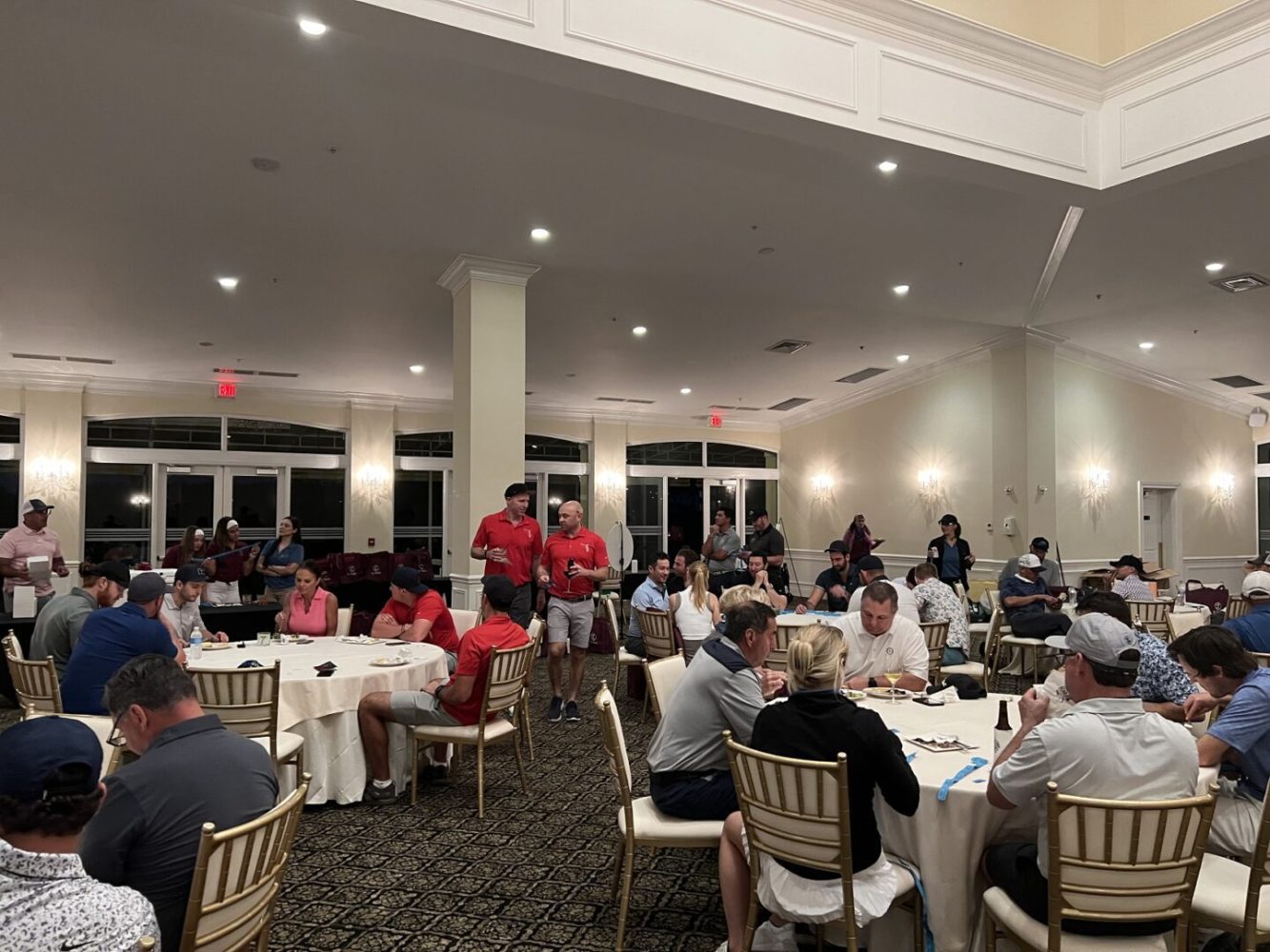 A group of people sitting at tables in a room.