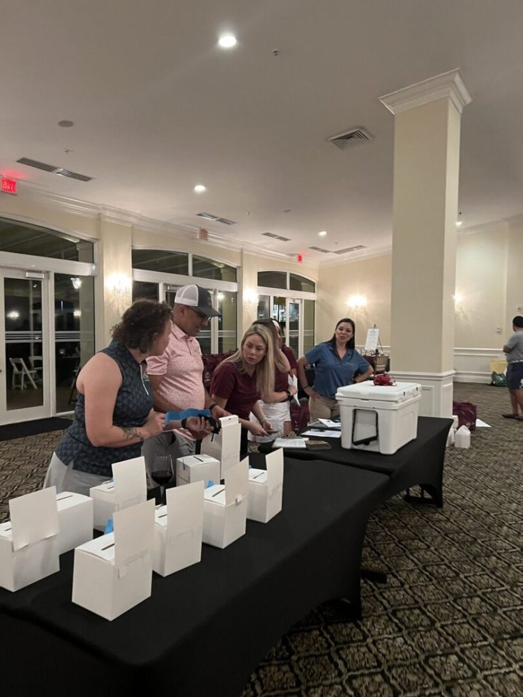 A group of people standing around a table.