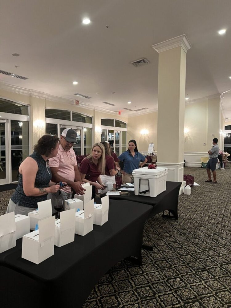 A group of people standing around a table.