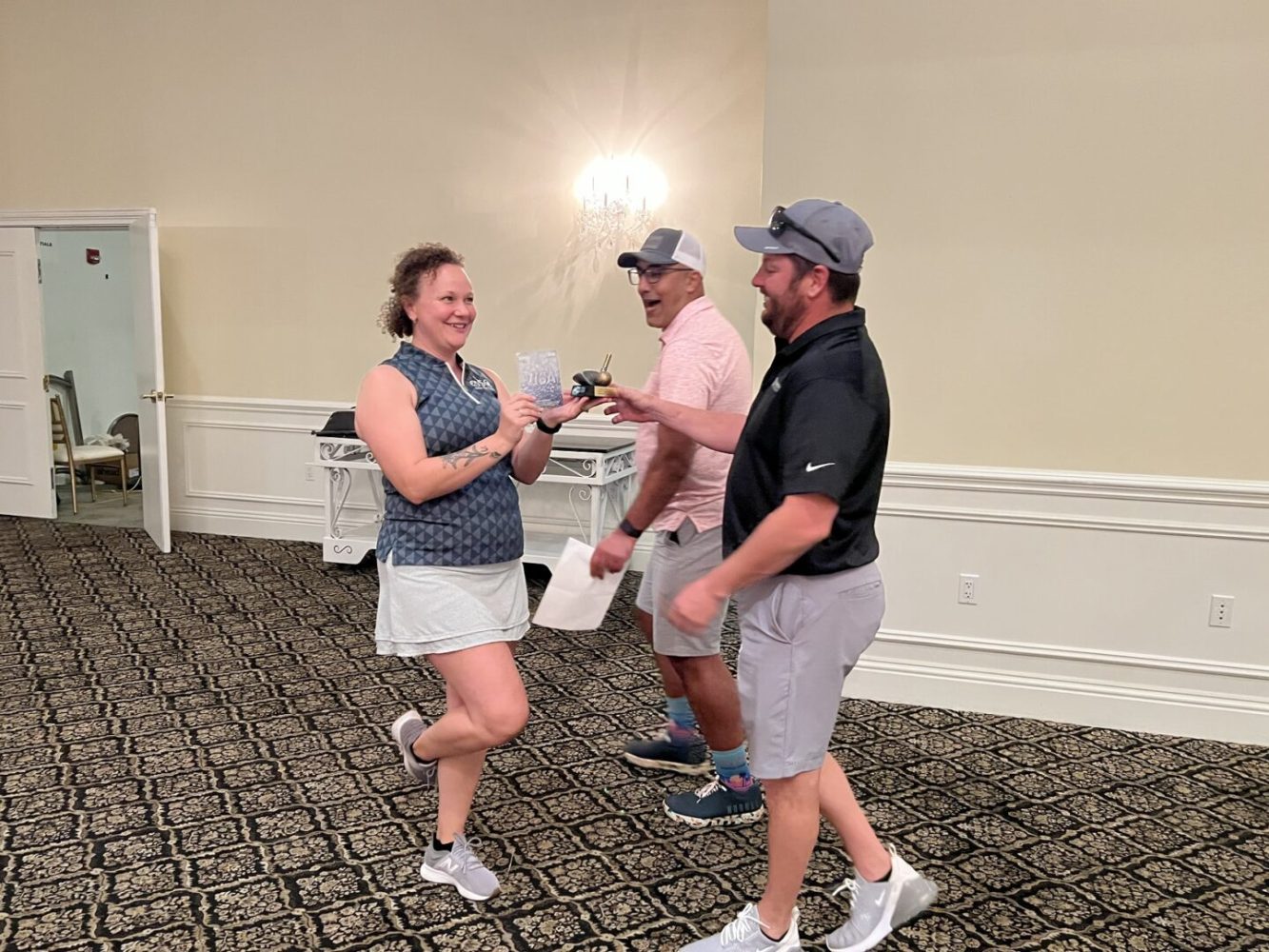 Three people are playing a game of golf.